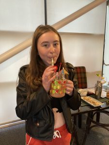 A young person drinking a mocktail in The Devil's Porridge Museum's café.
