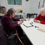 Two members of The Devil's Porridge Museum's Cordite Club playing dominos.