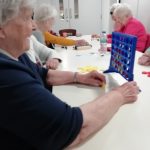 Cordite club members playing connect four.