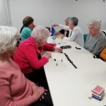 A table of Cordite Club members playing dominos and connect four.