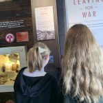 Two students looking at a periscope in The Devil's Porridge Museum.