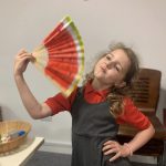 A young person holding their fan.