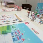 Nintendo themed craft activities on a table. There are photos of some Mario characters.