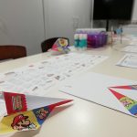 Some Nintendo themed craft activities on a table with paper planes.