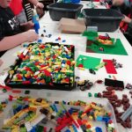 Lots of Lego and young people building structures from it.