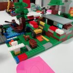 The first place Minecraft inspired Lego build, which features a boat on a river, a tree, a car, a dog and a building.